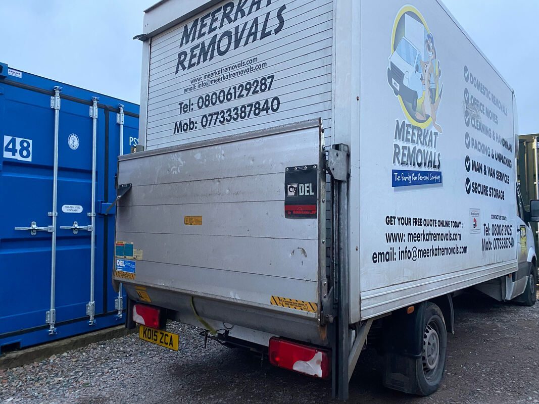 a van unloading at a shipping container storage unit