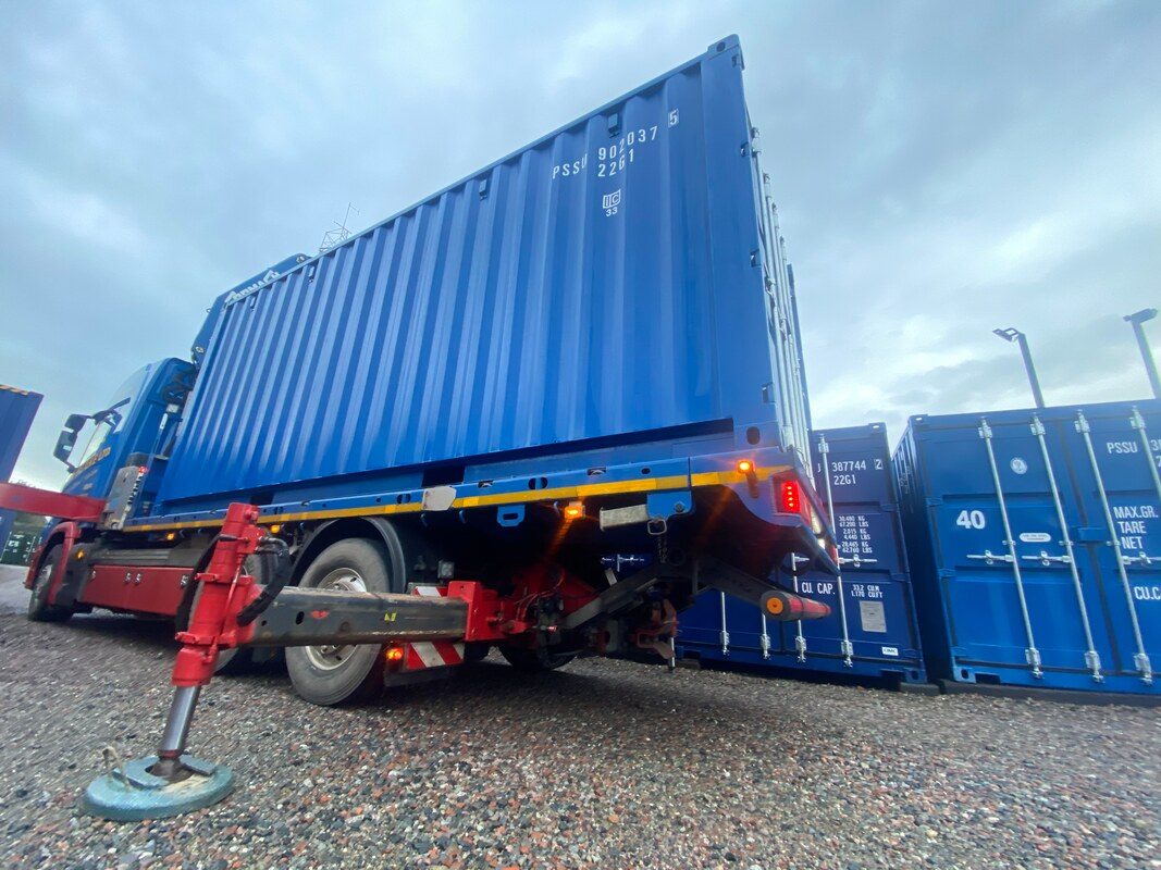 a HIAB lorry delivering a shipping container